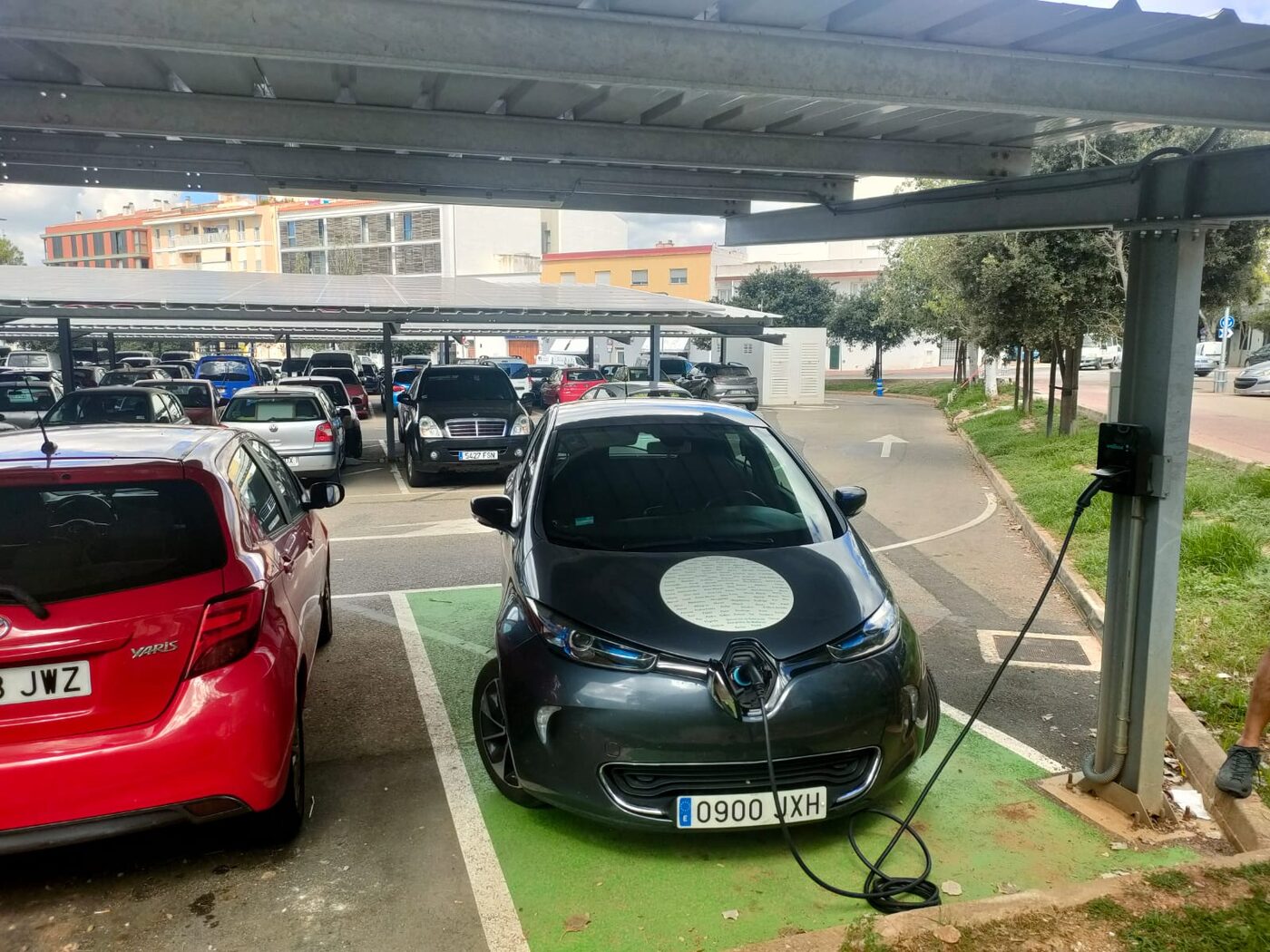 Electric car charging at a car park station in Spain