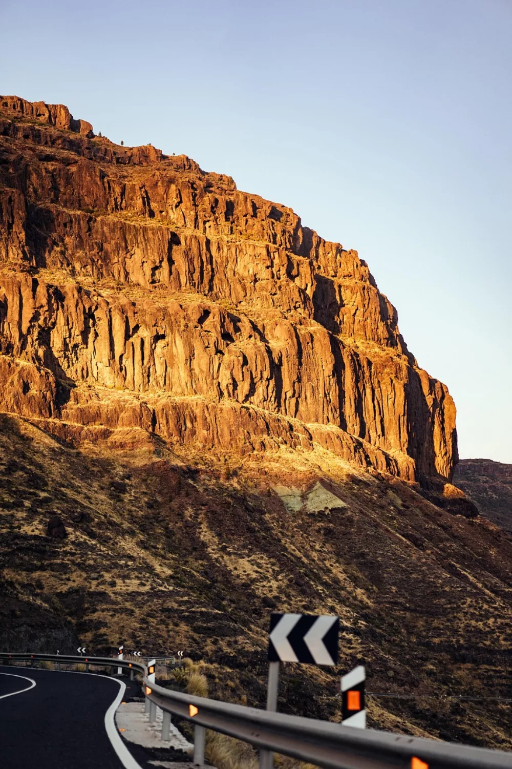 Winding road among volcanic cliffs in Spain